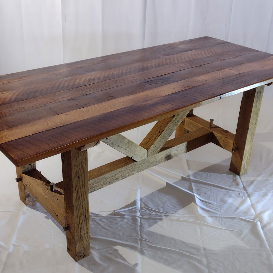The barnwood table is hand-crafted from lumber salvaged from 100+ year old barns. This reclaimed table is sure to enhance the beauty of any kitchen or dining room.<br /><br />The tabletop is primarily oak material reclaimed from old barns. It possesses a wide barn plank appearance with the original patina from the barn.<br /><br />The table base is hand-crafted mortise and tenon joinery. This provides quality and strength to make the table last for ages to come.